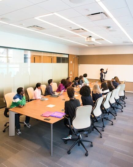Professional team engaged in a collaborative boardroom meeting with a presentation in progress.